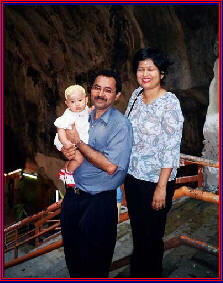 Hindu couple and baby in Hindu Temple at Malaysia's Batu Cave 